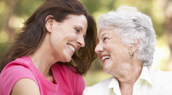 a parent and child smile at each other